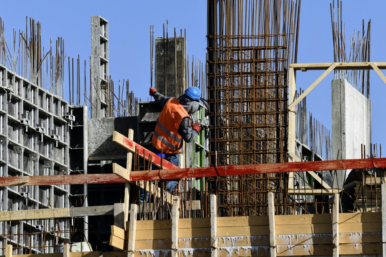 Worker assembling a structure at a construction site